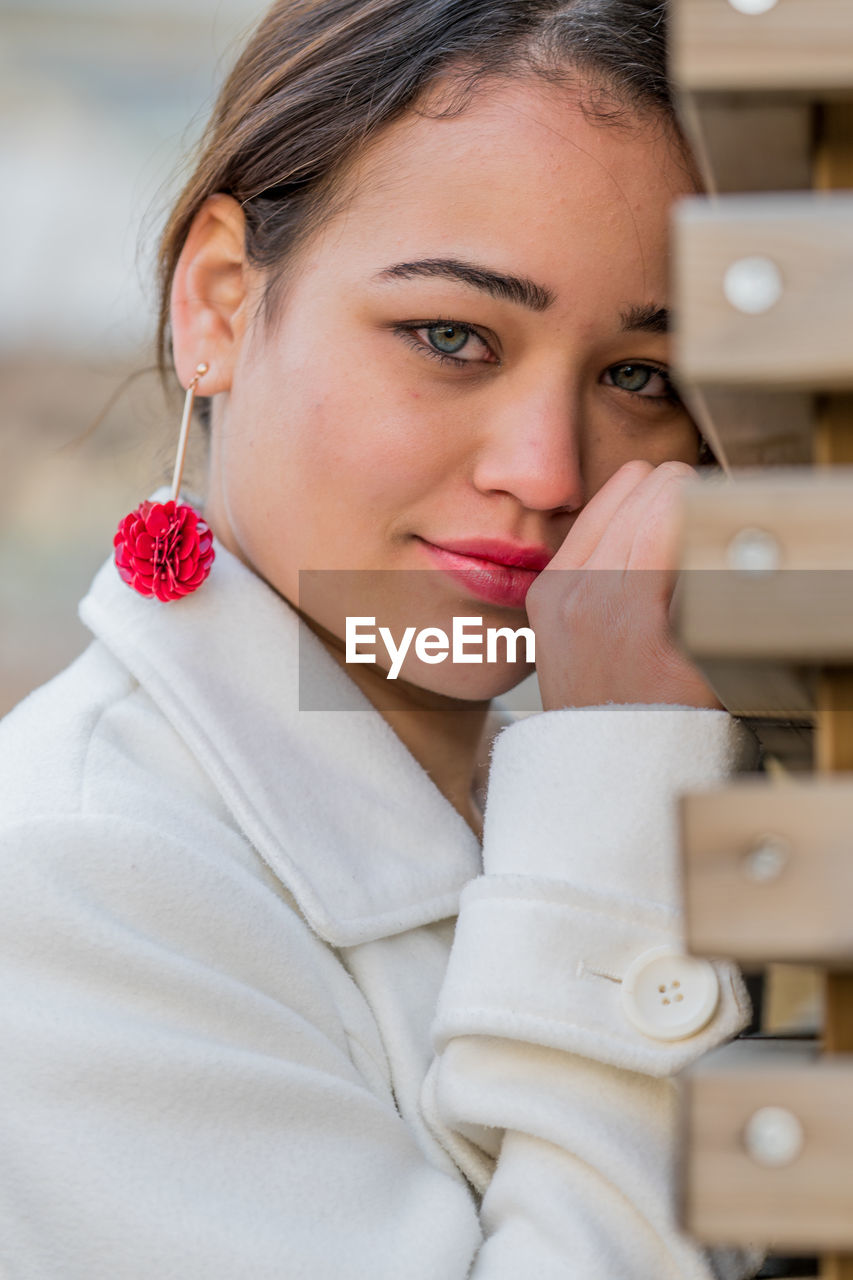 Portrait of young woman posing outdoors