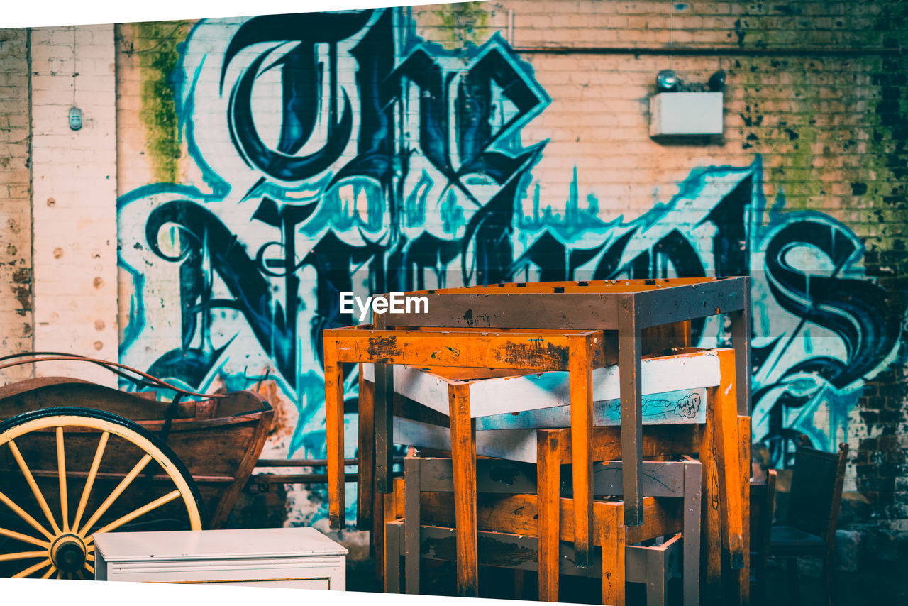 GRAFFITI ON WALL OF TABLE AND CHAIRS