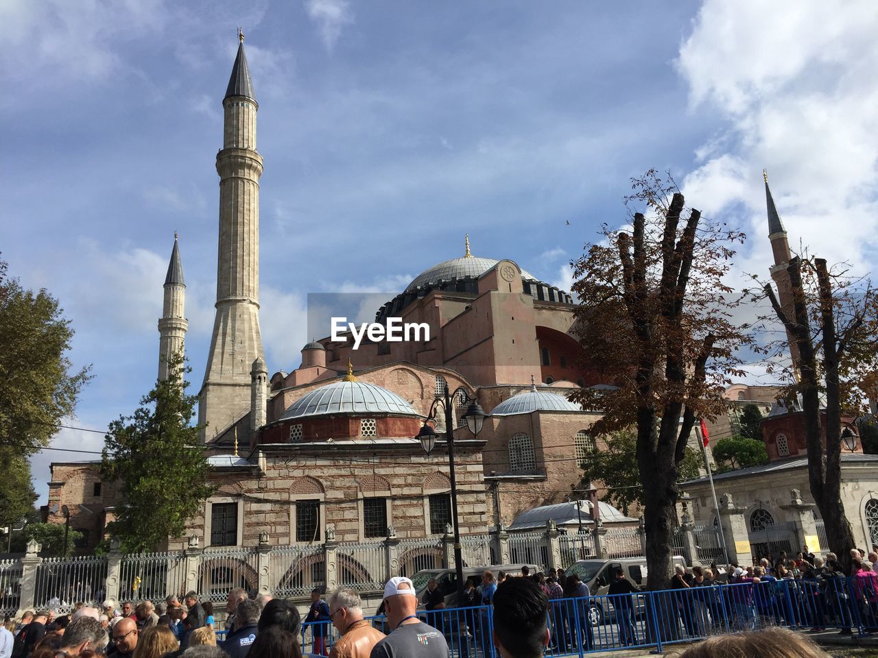 People at mosque against sky
