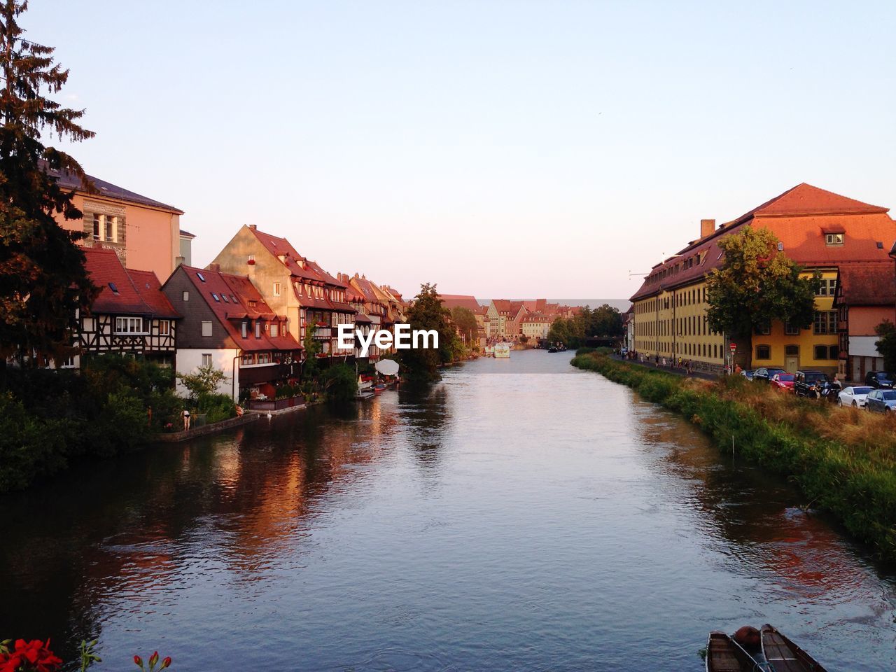 River amidst houses against clear sky