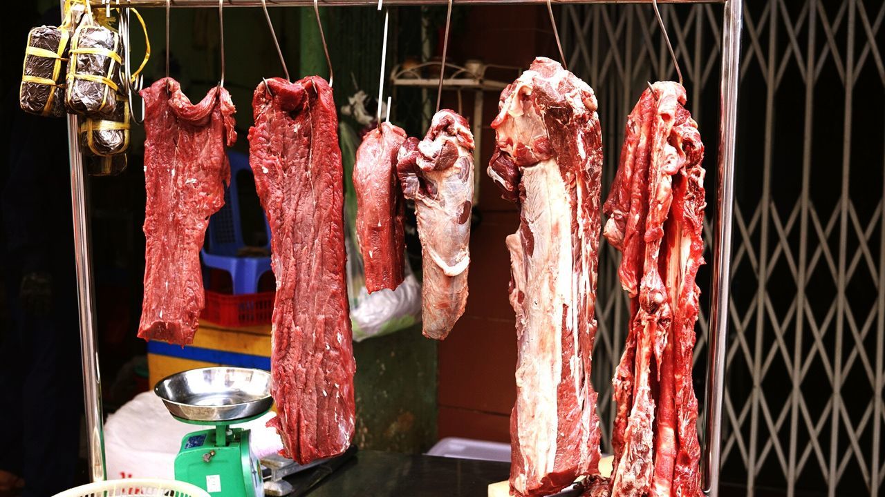 Meats hanging at store in market for sale