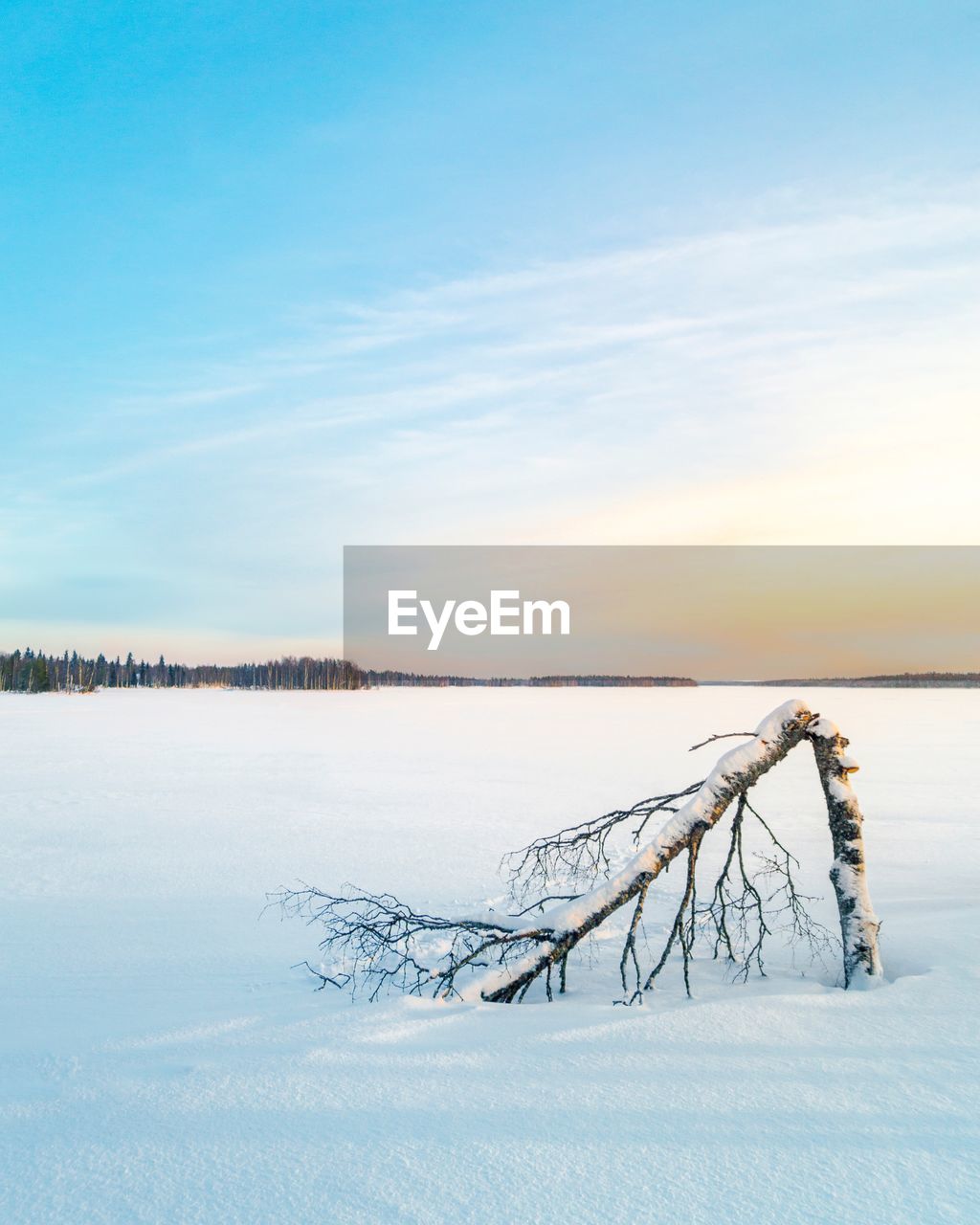 Scenic view of frozen lake against sky during winter