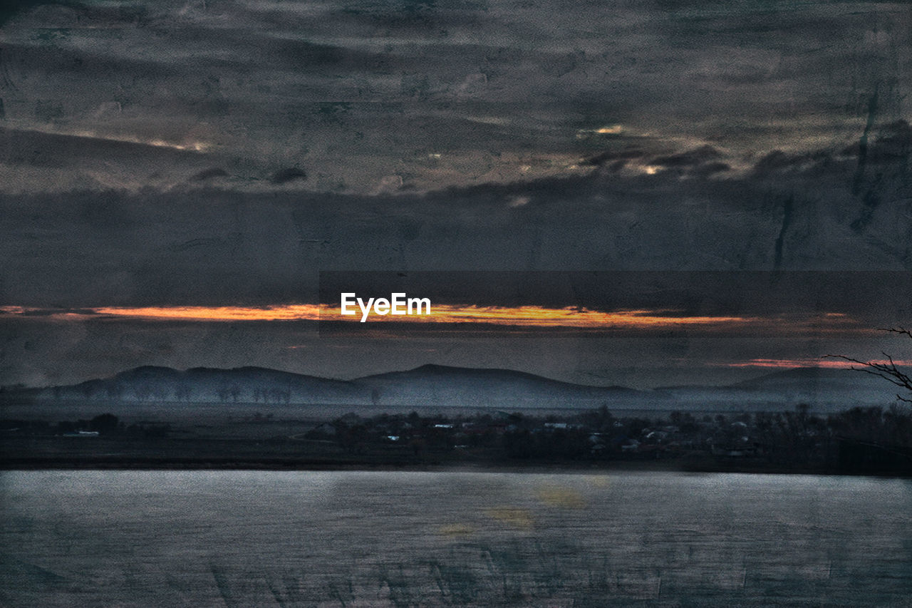 SCENIC VIEW OF MOUNTAIN AGAINST SKY DURING SUNSET