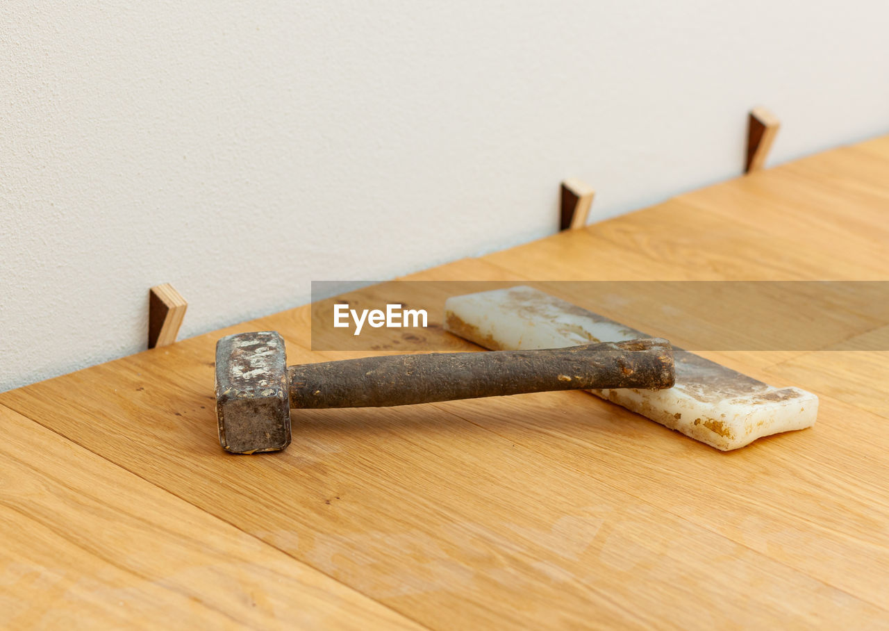 close-up of hammer on wooden table