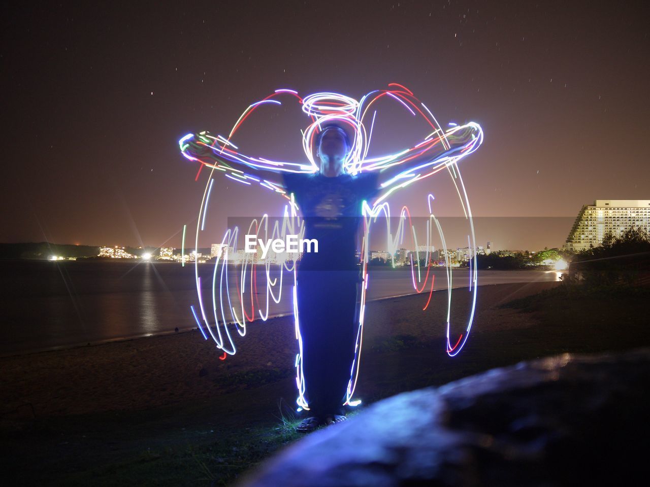 MAN AT ILLUMINATED NIGHT