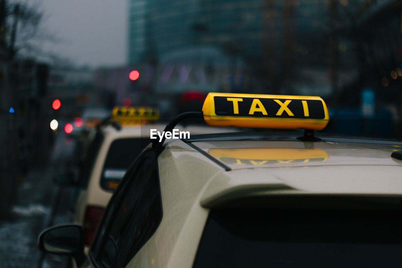 View of taxis on city street