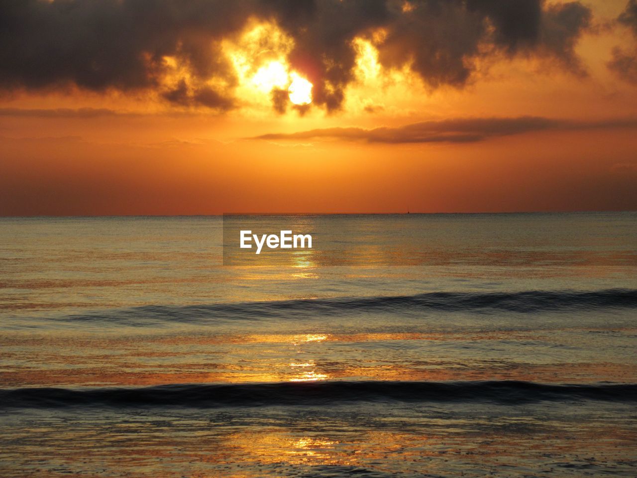 Scenic view of sea against romantic sky at sunset