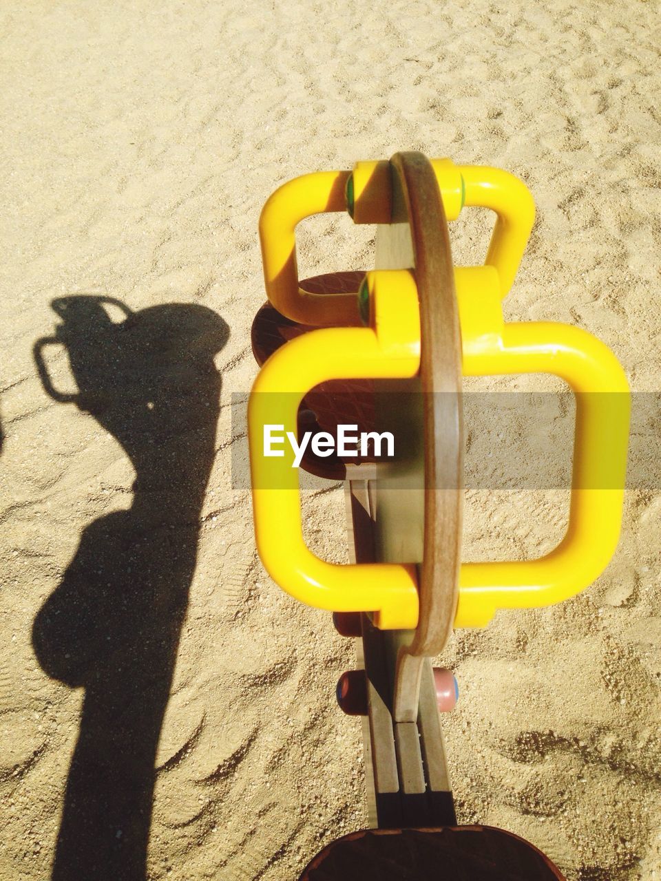 Close-up of play equipment on sand in park