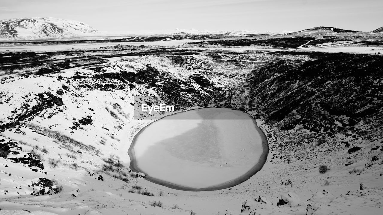 Scenic view of snow covered land against sky