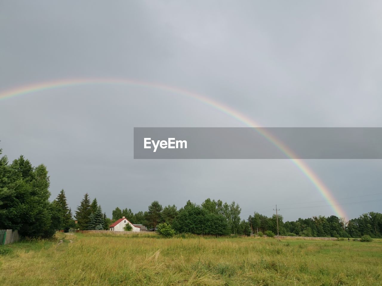 SCENIC VIEW OF RAINBOW OVER FIELD