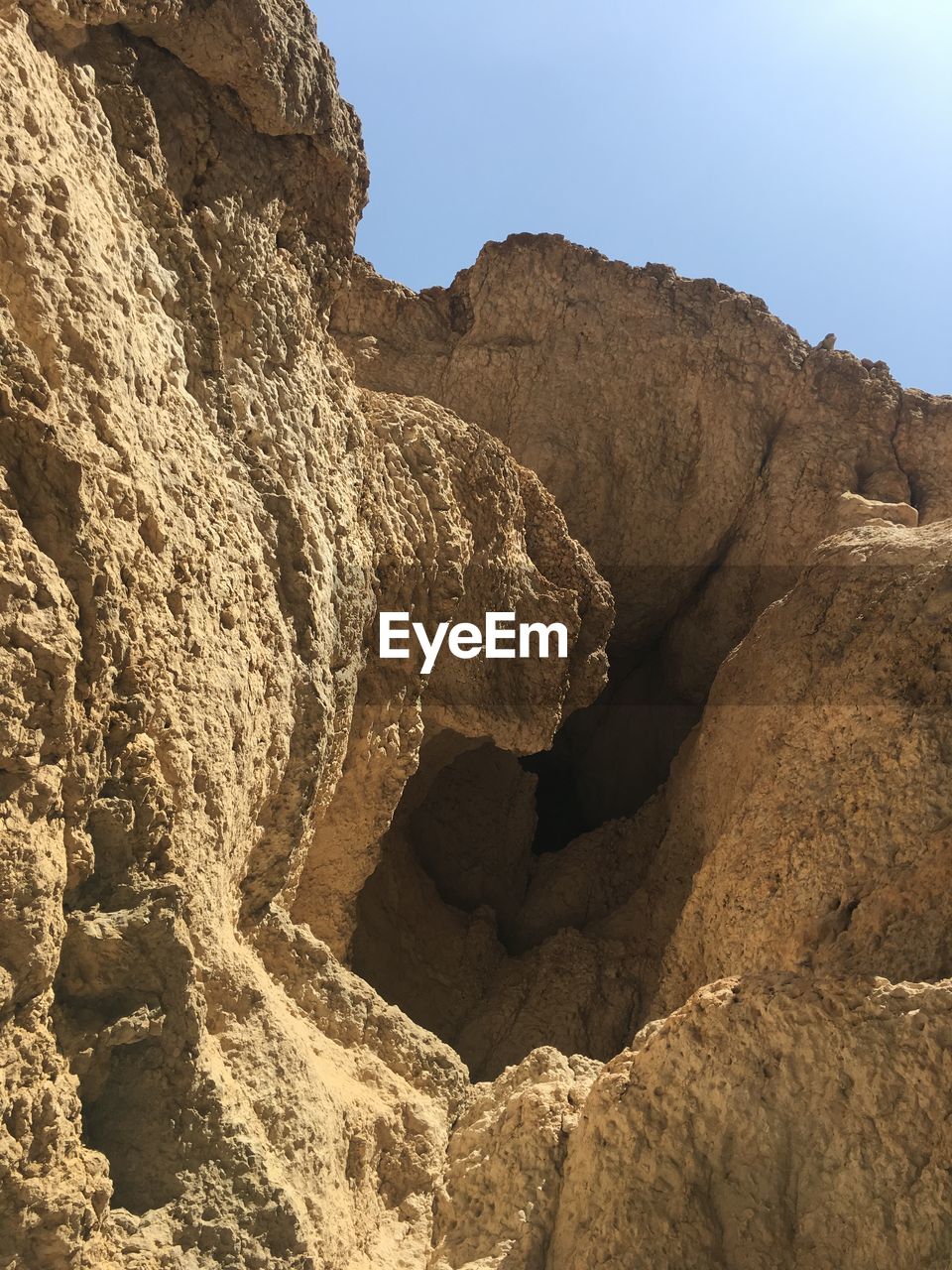 Low angle view of rock formation against sky