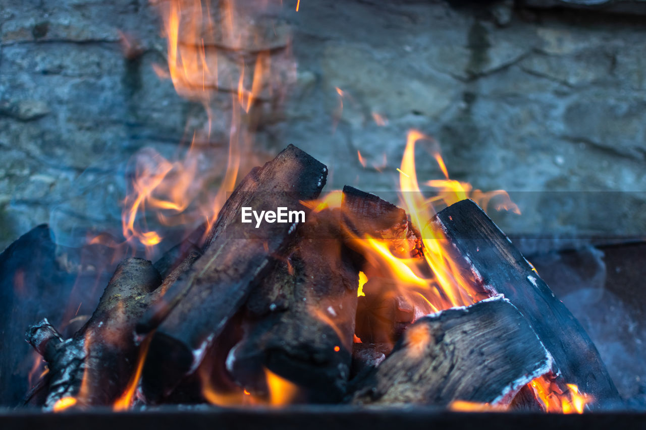 Flaming barbecue bonfire on the background of a stone wall