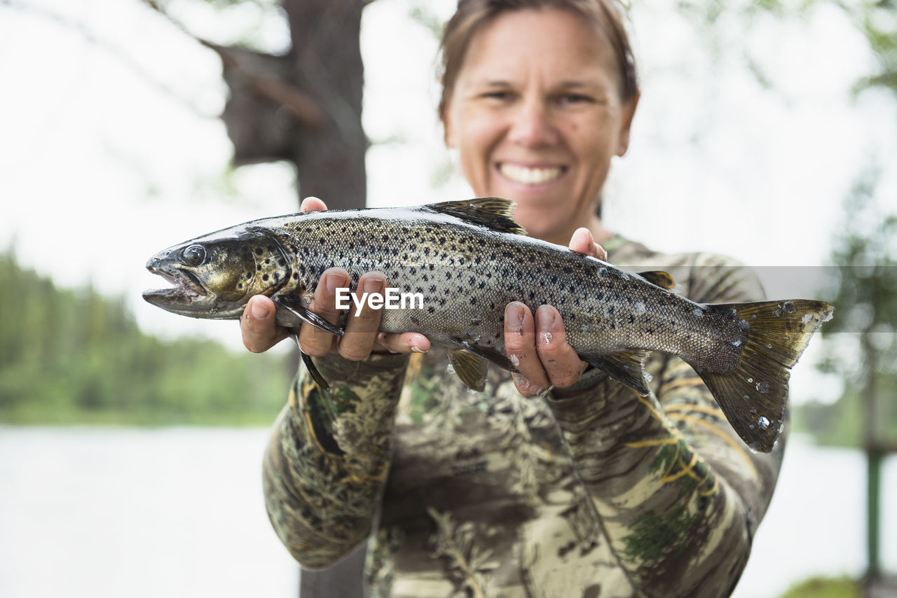 Woman holding caught fish