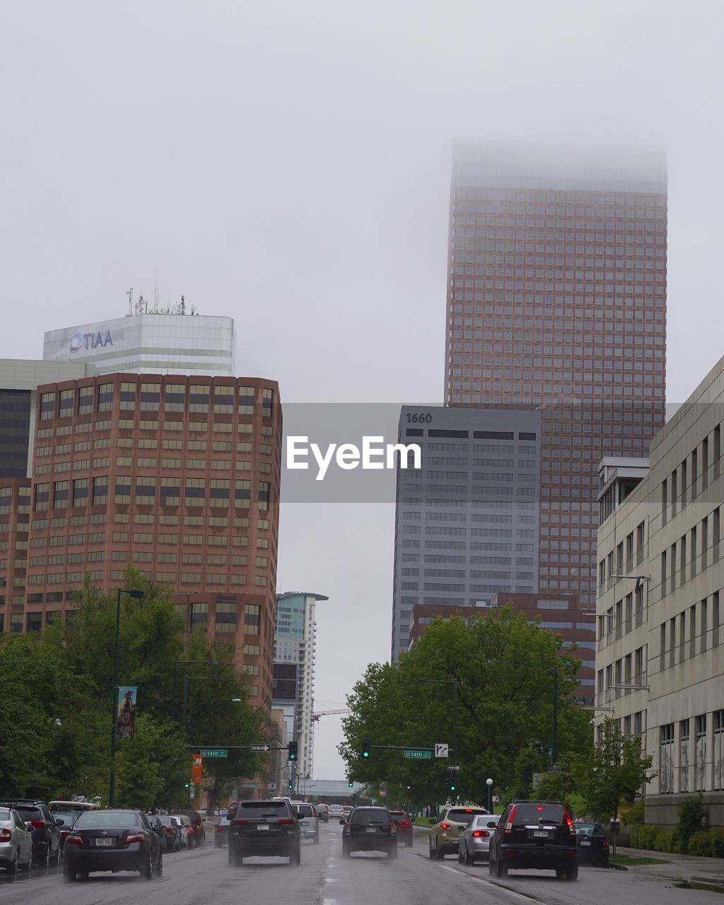 CARS ON ROAD AGAINST BUILDINGS