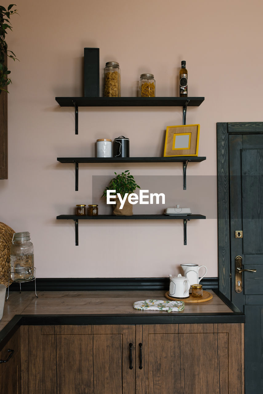 The kitchen is in the scandinavian style. wooden shelves with decor