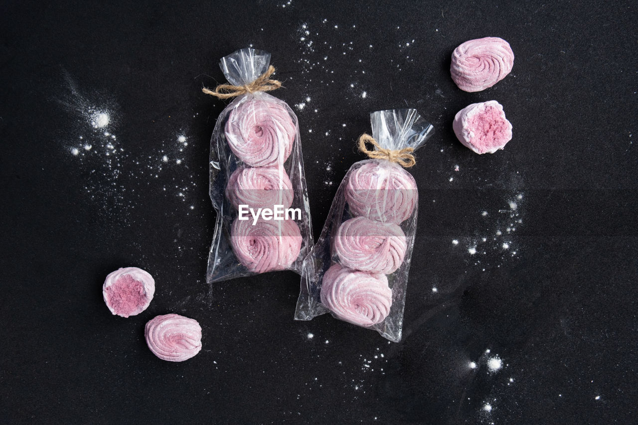 High angle view of pink dessert on table against black background