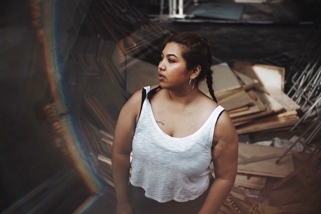 High angle fish-eye lens shot of overweight woman looking away outdoors