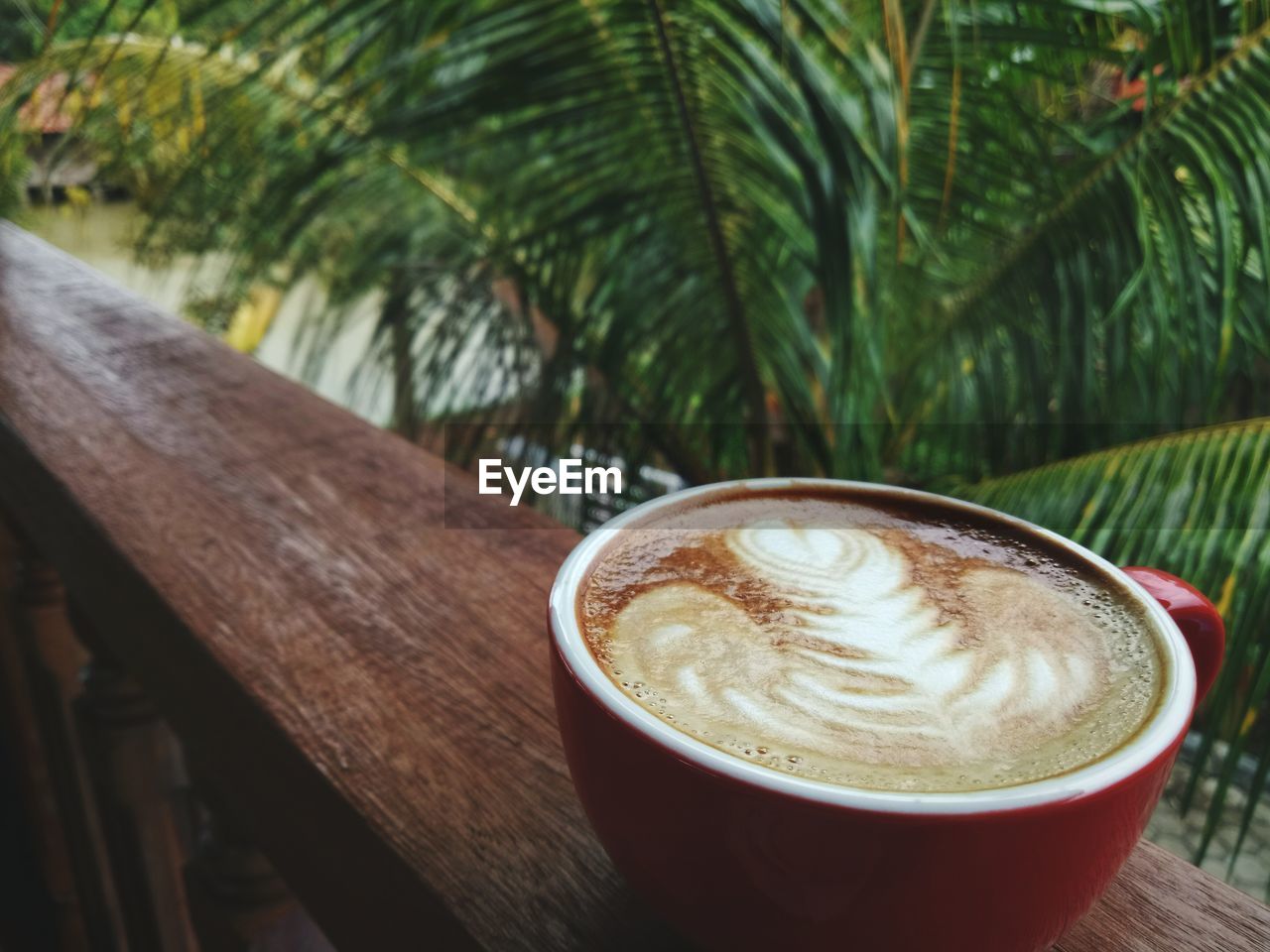 Close-up of coffee on railing