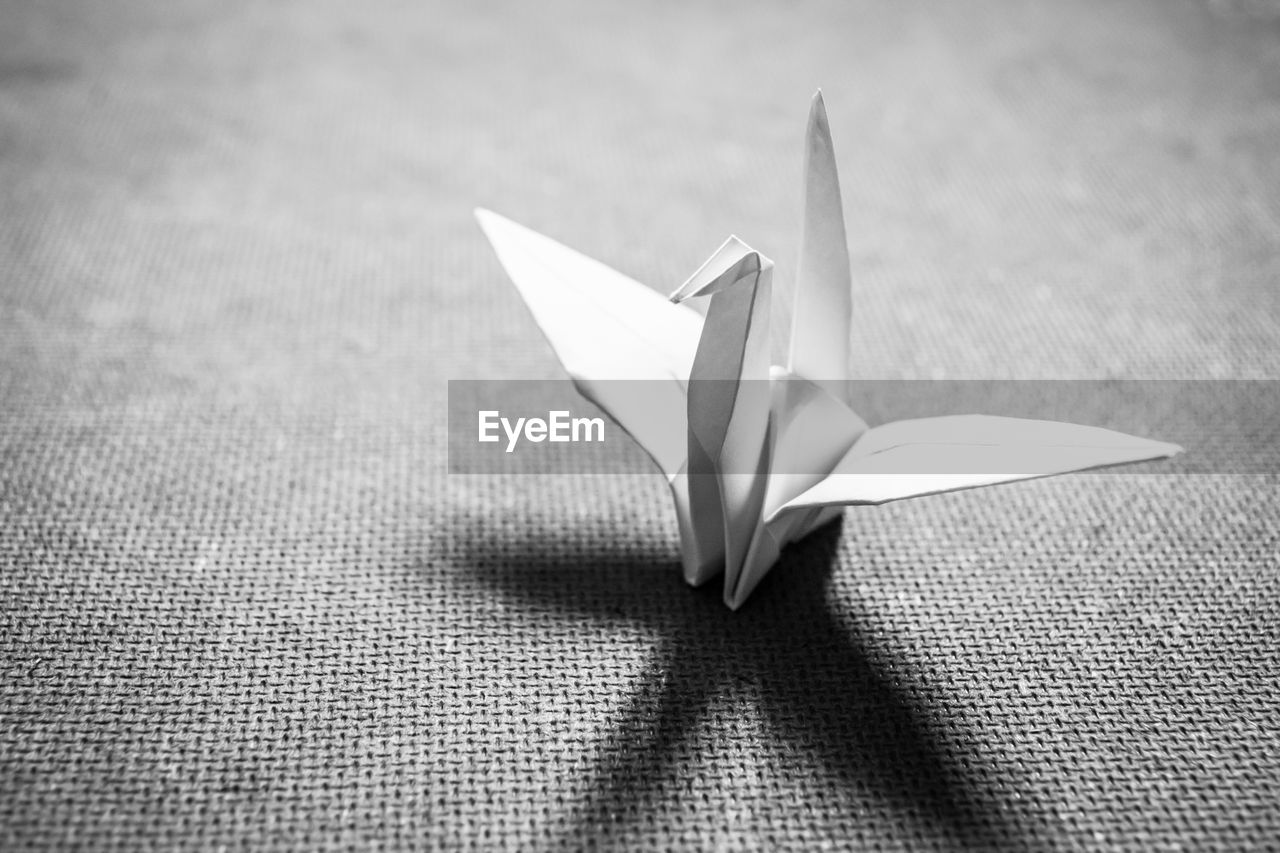 Close-up of paper crane on table