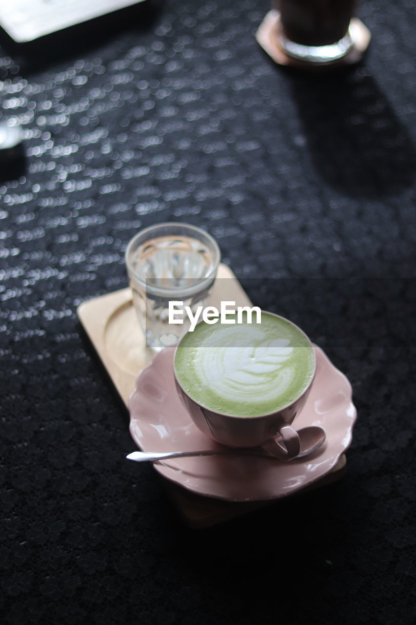 food and drink, hand, drink, refreshment, high angle view, food, freshness, indoors, directly above, cup, green, close-up, black, jewellery, flower, still life, glass, table, healthy eating, macro photography, hot drink, mug