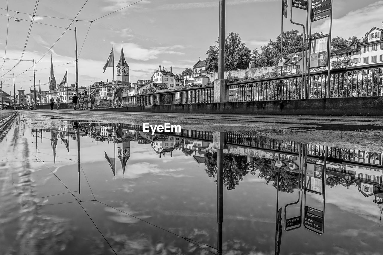 REFLECTION OF BUILDING IN PUDDLE