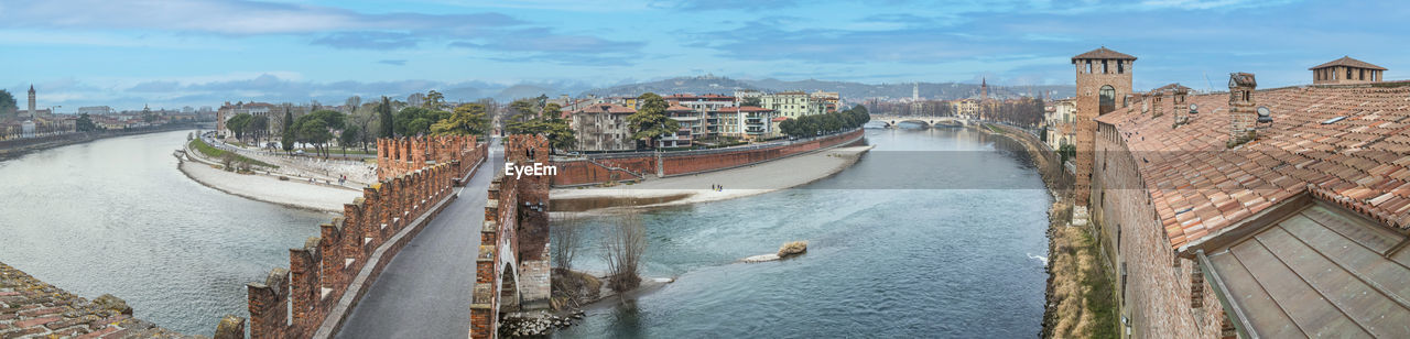 Extra wide angle view of the adige river, the panorama of verona and the castelvecchio bridge