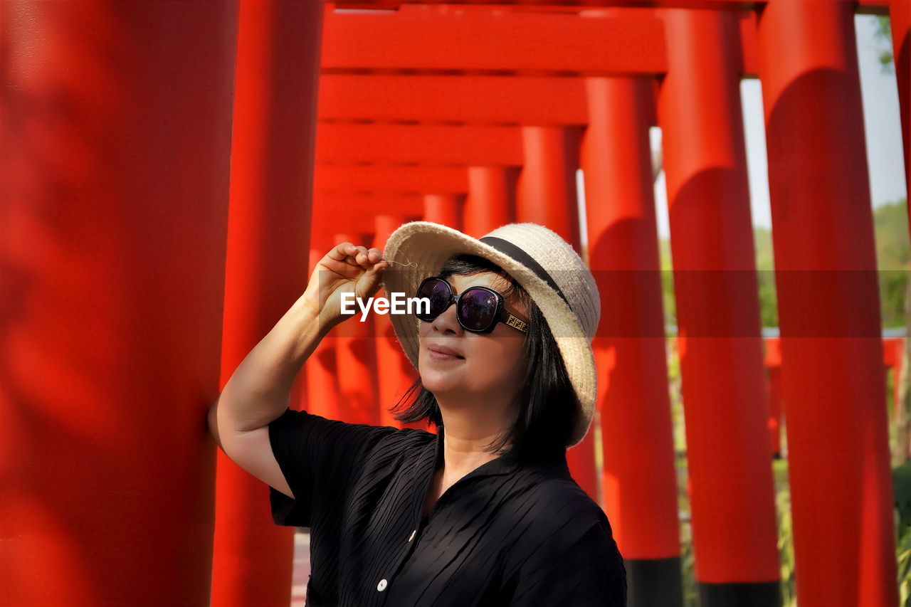 Senior woman wearing hat looking away at temple