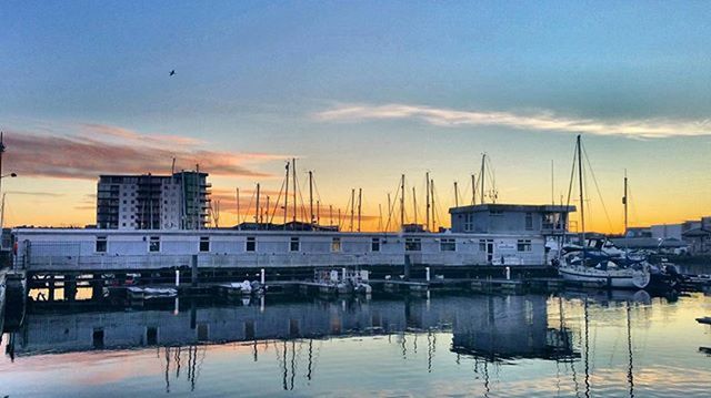 BOATS MOORED AT HARBOR