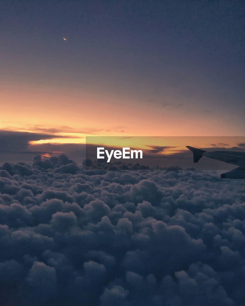 AERIAL VIEW OF CLOUDSCAPE OVER AIRPLANE WING