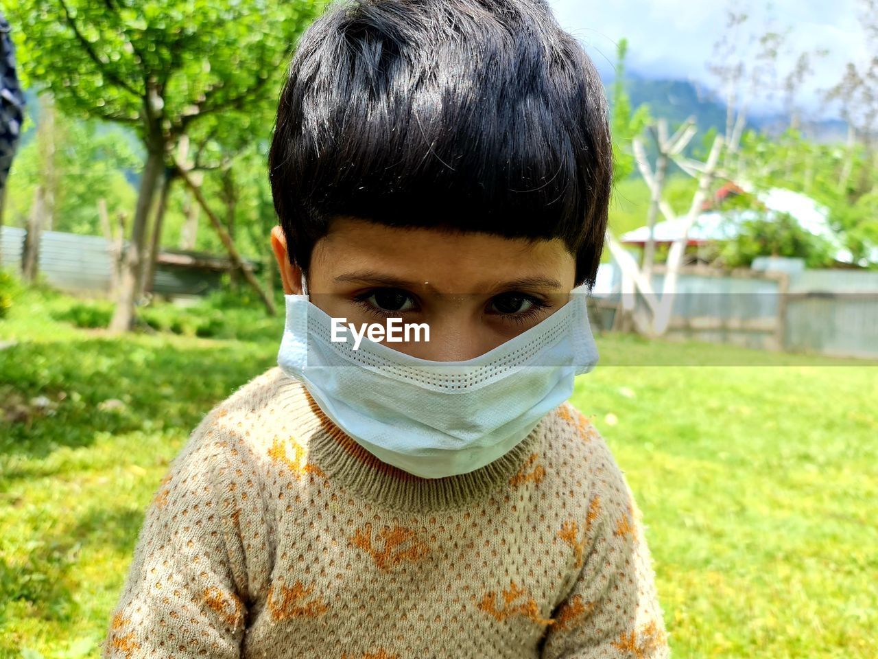 Portrait of boy wearing sunglasses on field