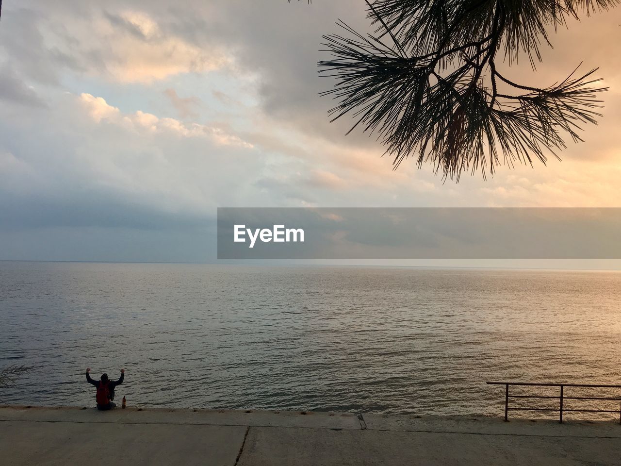 PEOPLE ON BEACH AGAINST SKY