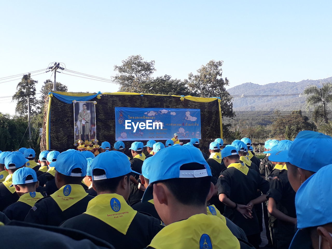 REAR VIEW OF PEOPLE AGAINST CLEAR SKY