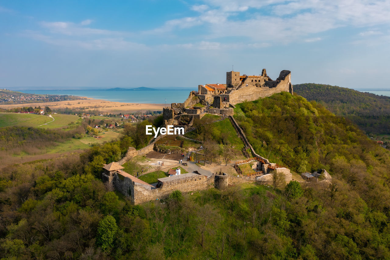 Aerial view about castle of szigliget with lake balaton at the background. spring landscape.