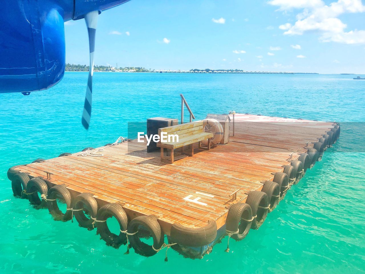 CHAIRS BY SWIMMING POOL AGAINST SEA