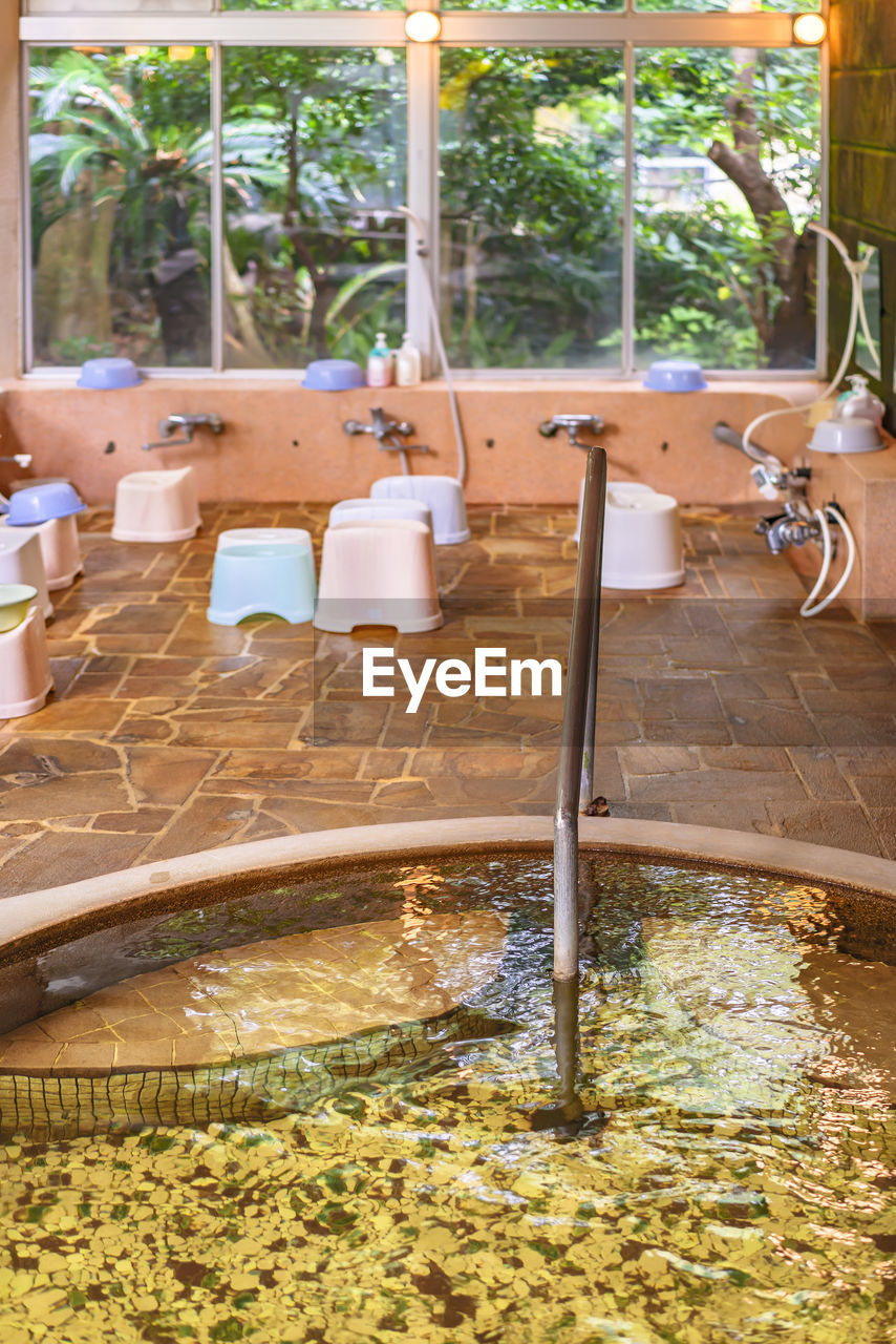 Japanese onsen hot spring with furo-isu bath chairs, shower taps or faucets and karan buckets.