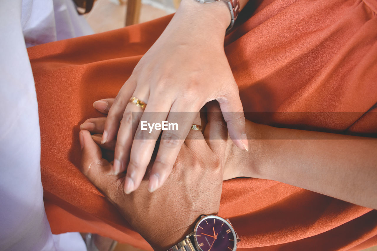 adult, hand, women, watch, ring, two people, female, finger, arm, nail, close-up, men, limb, jewelry, midsection, human leg, togetherness, person, clothing, time, lifestyles, fashion accessory, young adult, love, indoors, positive emotion