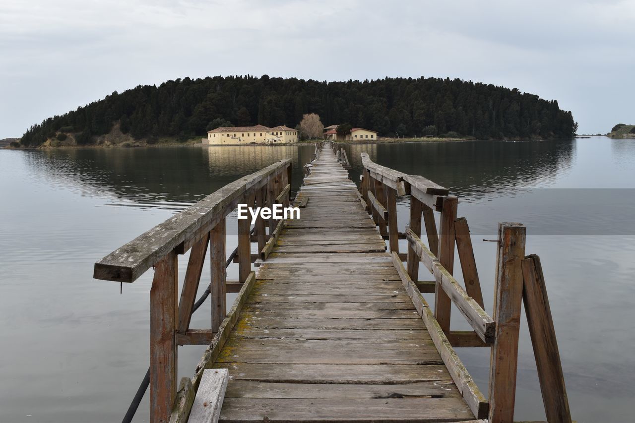 Damaged wooden pier over water against sky in saint mary monastery, zvernec