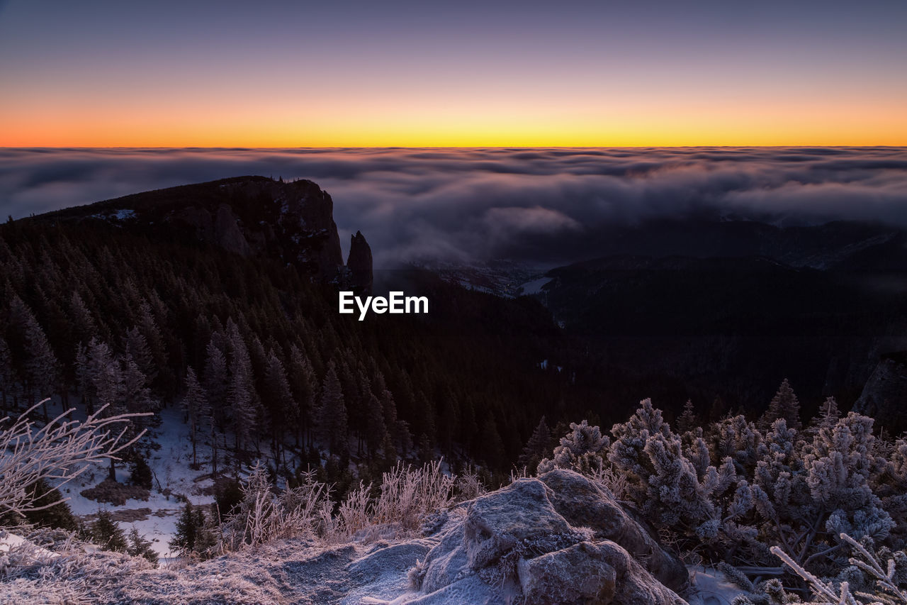 Scenic view of mountains against sky during winter