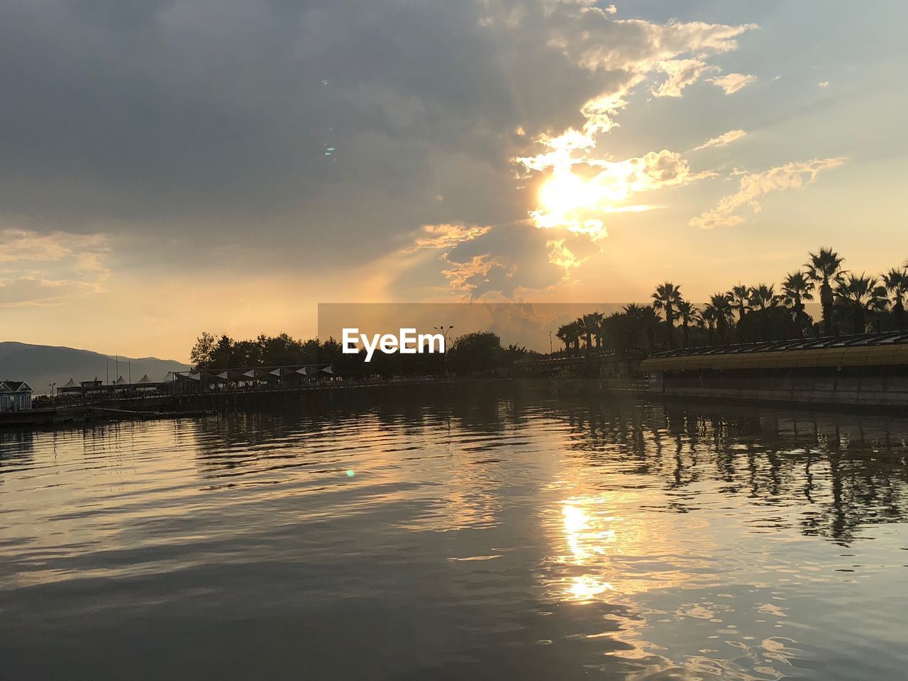 SCENIC VIEW OF LAKE AGAINST ORANGE SKY