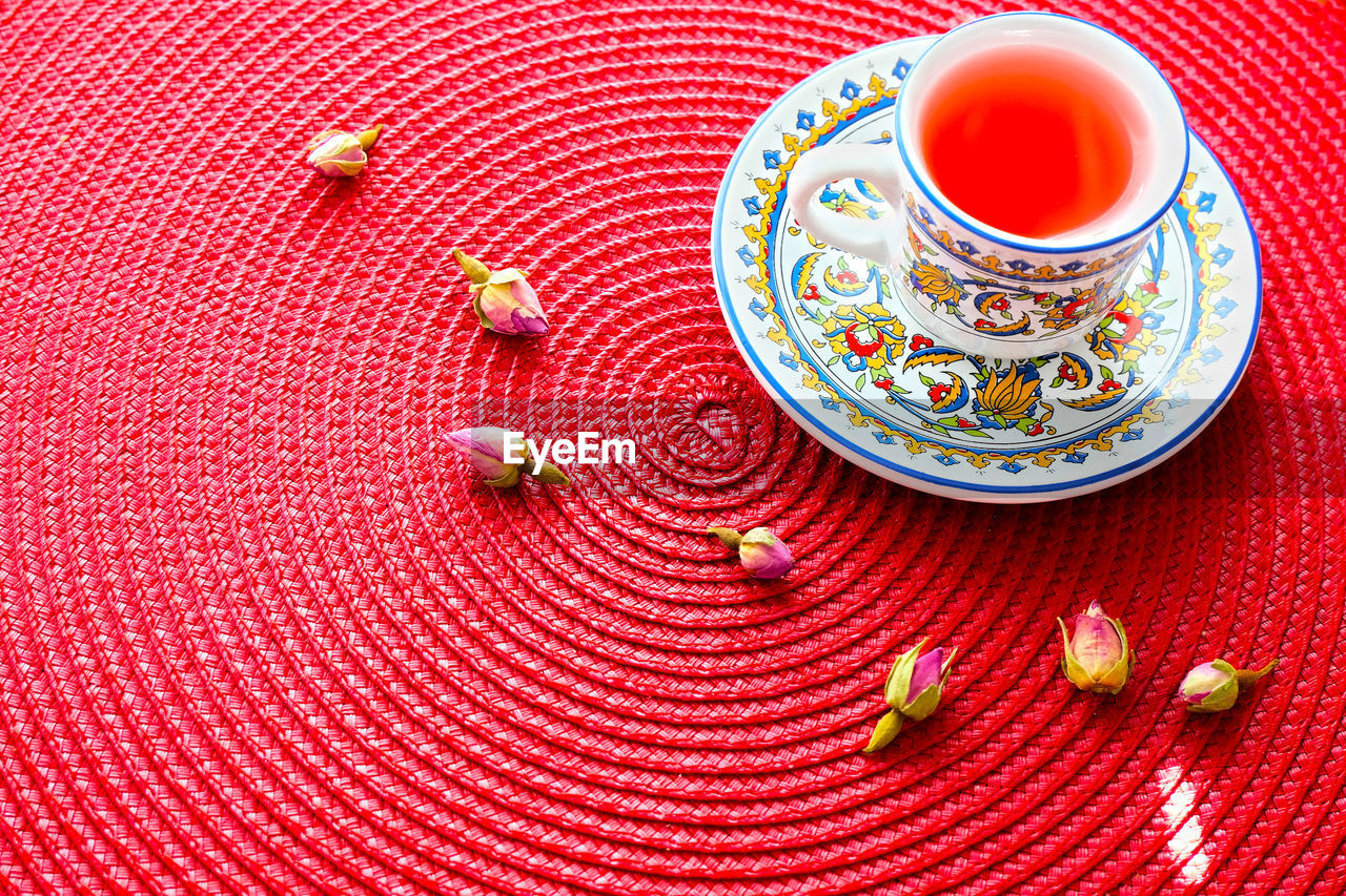 High angle view of tea cup and dried rosebuds