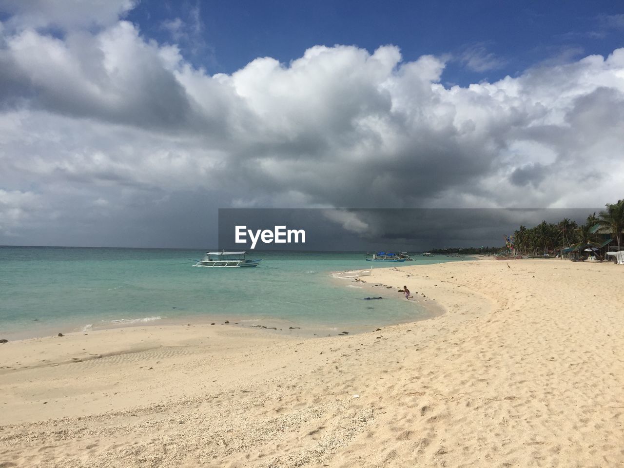 View of beach against cloudy sky