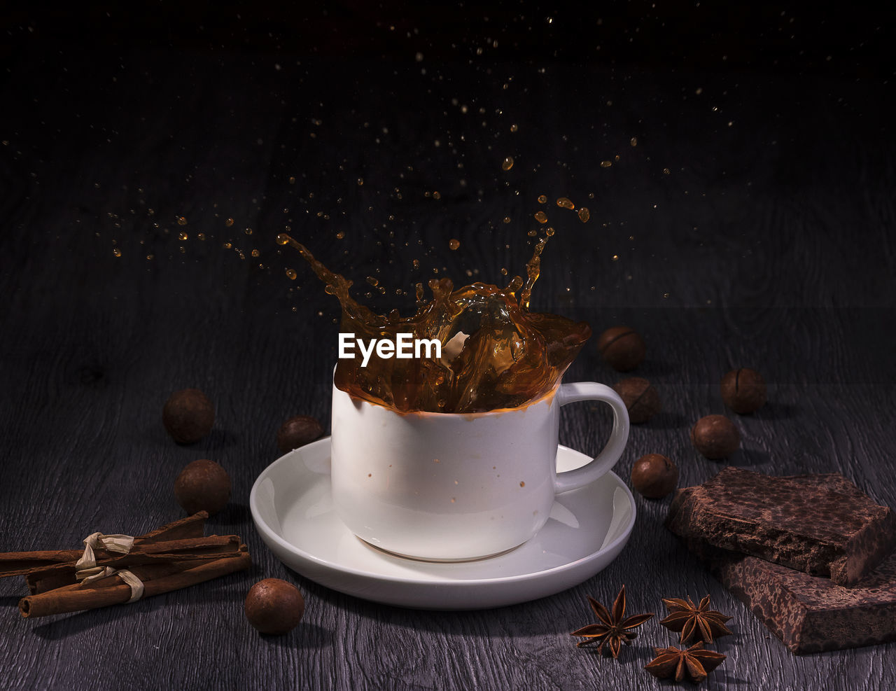 COFFEE CUP ON TABLE AGAINST WALL