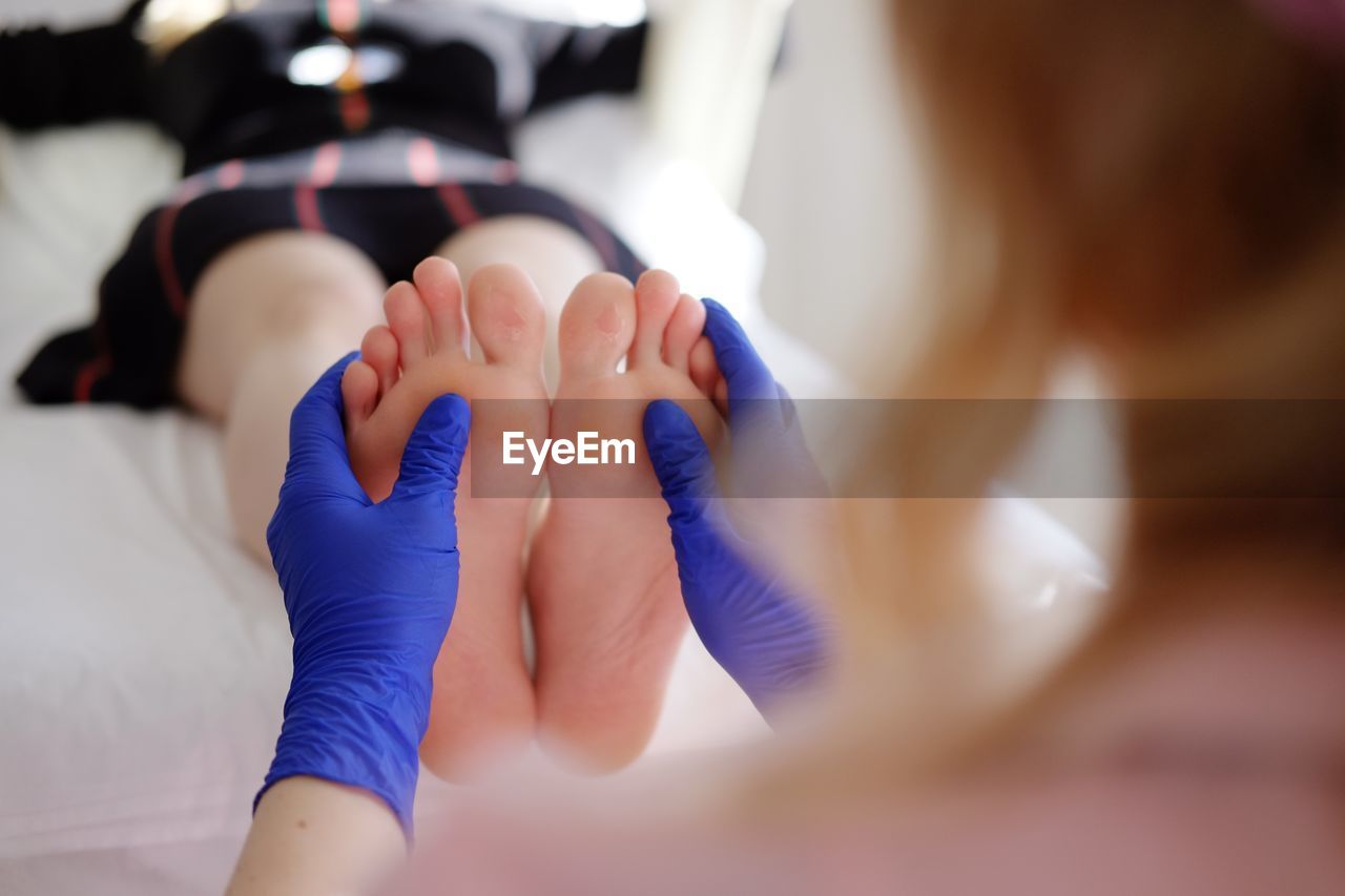 Masseuse massaging woman at health spa