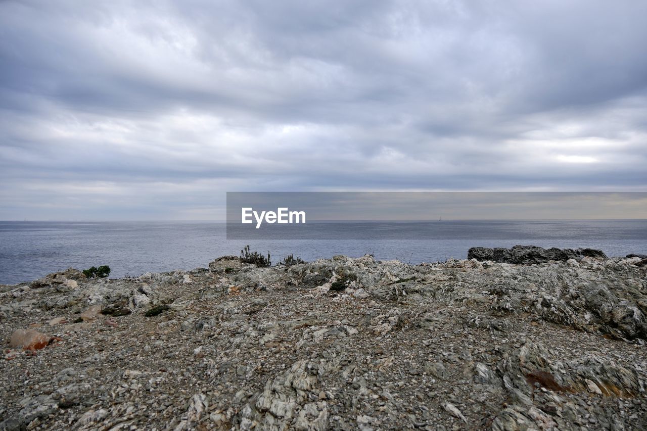 Scenic view of sea against cloudy sky