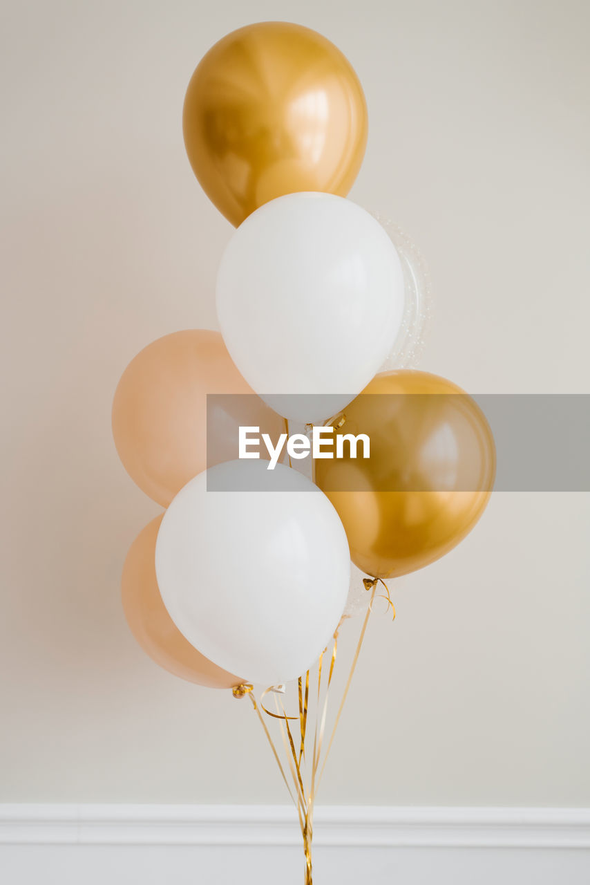 balloon, helium balloon, celebration, studio shot, indoors, mid-air, no people, helium, event, party, group of objects, toy, copy space, yellow, ribbon, anniversary, decoration