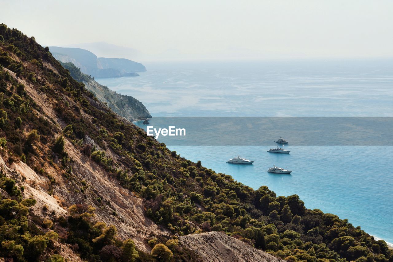 High angle view of boats in sea against clear sky