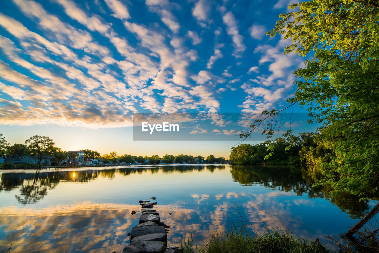 Scenic view of lake against sky at sunset