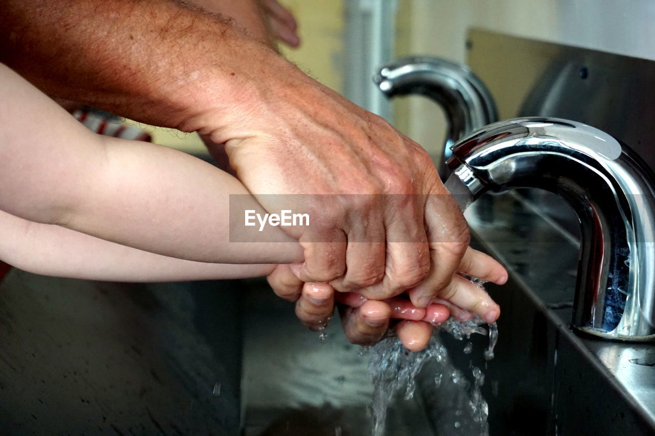 Cropped image of washing hands