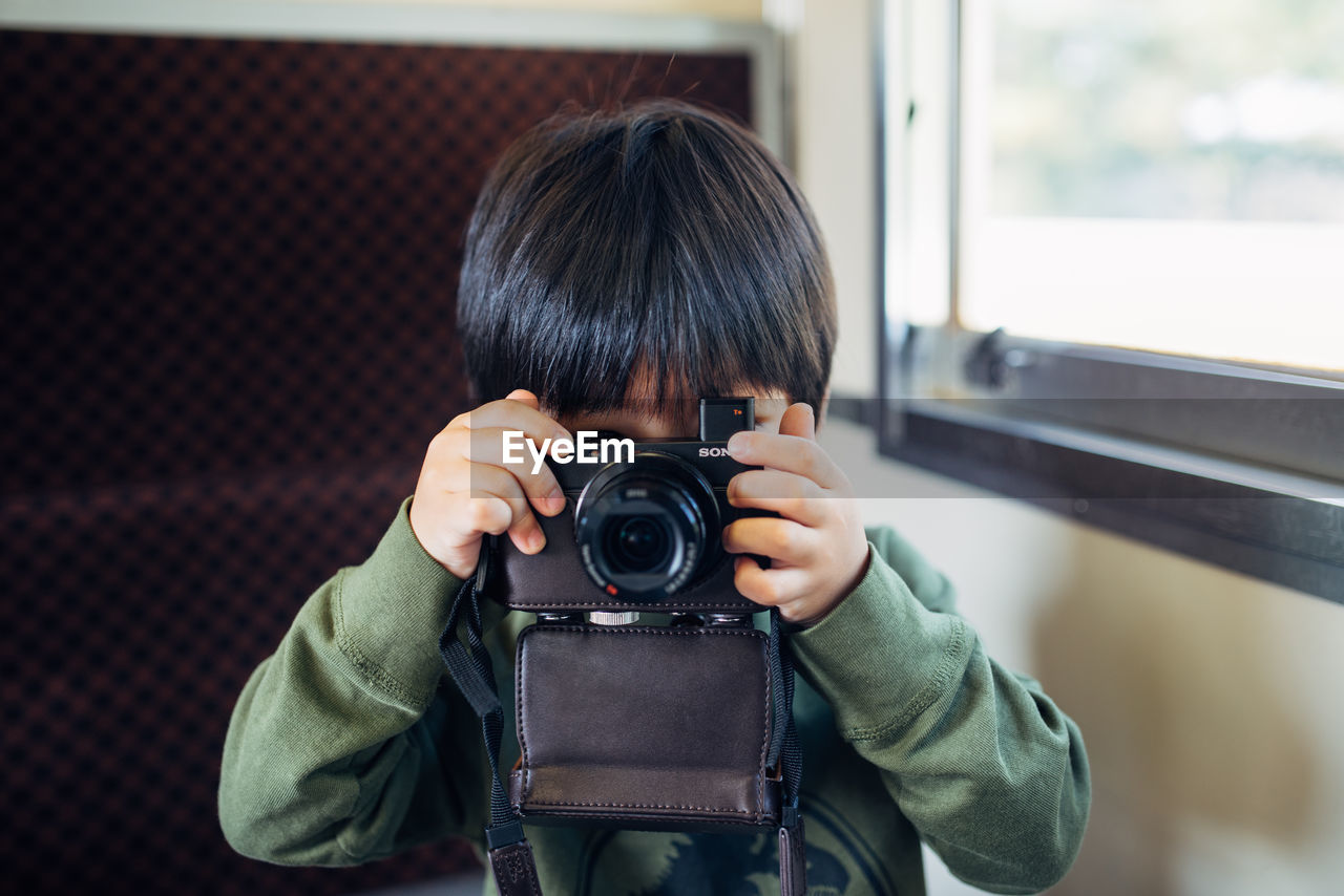 Portrait of boy photographing