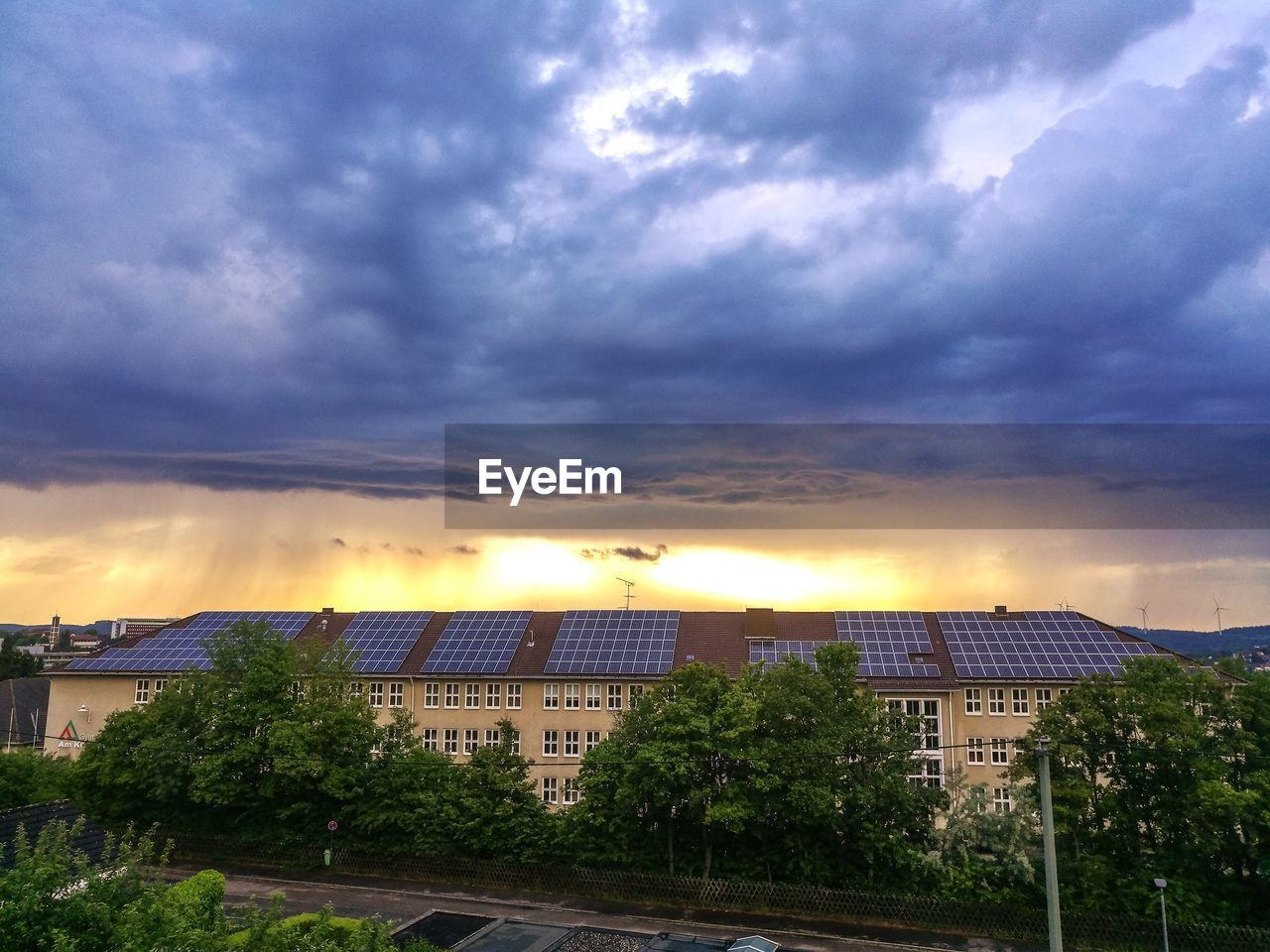 Building against cloudy sky during sunset